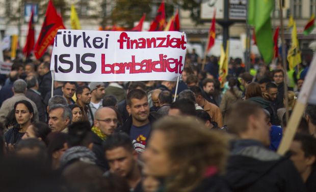 People hold a banner during an Oct. 12 demonstration in Berlin against the Islamic State militant group, known as ISIS, and its insurgent attacks on the Syrian Kurdish town of Kobani. Muslim leaders worldwide have issued a stern rebuke to ISIS. (CNS photo/Hannibal Hanschke, Reuters)