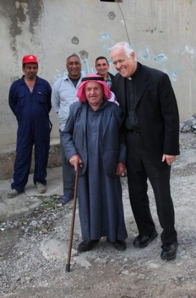 Msgr. John E. Kozar, president of the Catholic Near East Welfare Association, poses with a villager April 2 in Batnaya, Iraq. Msgr. Kozar was on a March 31-April 5 pastoral visit to Iraq. (CNS photo/courtesy John E. Kozar, CNEWA) 