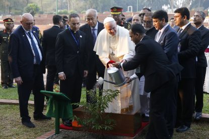 Pope Franci waters a tree he planted during a visit to the National Martyrs Memorial in Savar Bangladesh Nov. 30