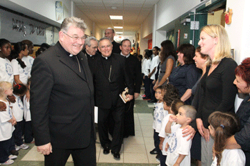 Archbishops Duka and Chaput, Cardinal Rigali and Father Alfred Bradley (director of the shrine) are greeted through St Peter school hallway by students as they head to the shrine