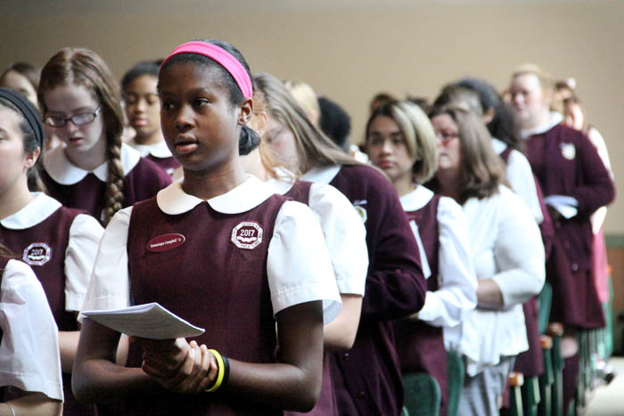 Sophomore Dominique Campbell prays along with fellow students