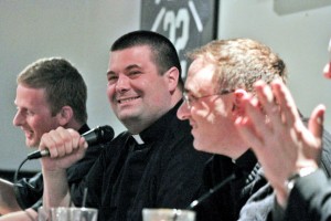 Father Tom Whittingham (center, with microphone) has fun answering questions along with other priests, from left, Fathers David Friel and Sean Bransfield. Also on the panel was Father Joseph Bongard.