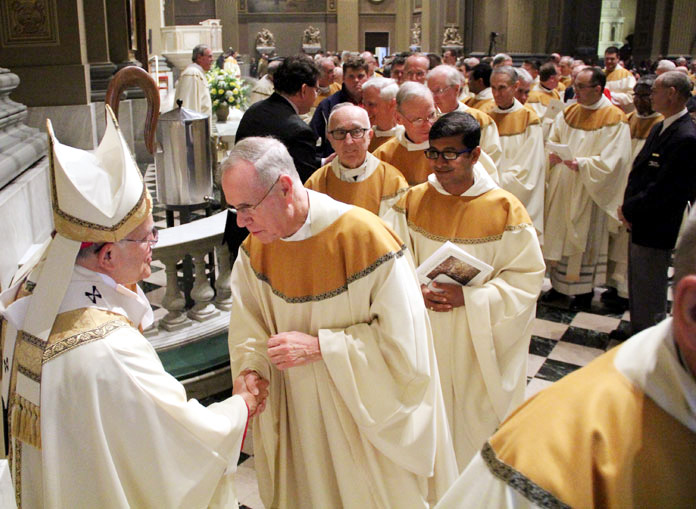 Chaput greets Msgr. Michael McCormac and all the other priests after mass