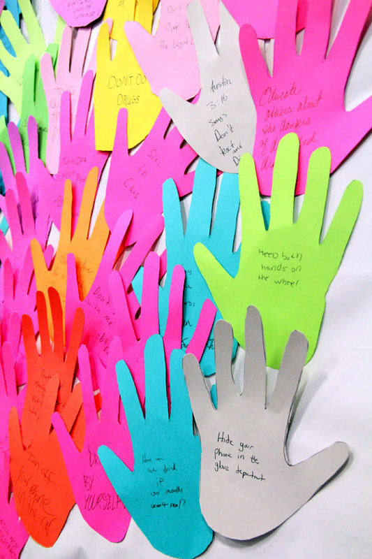 Students wrote on hands things they learned or can pledge to do to not be a distracted driver.
