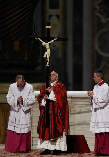 Pope Francis holds the crucifix during the Good Friday liturgy in St. Peter's Basilica at the Vatican April 3. (CNS photo/Paul Haring)