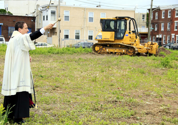 Bishop John McIntyre blesses the ground where St Francis Inn Senior Housing will be bulit.