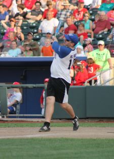 Father Andrew Roza, of the Archdiocese of Omaha, Neb., takes a cut at a pitch. (CNS photo/Susan Szalewski, Catholic Voice) 
