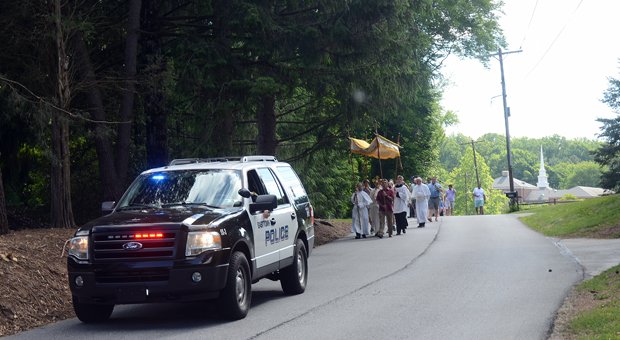 An Easttown Township police officer escorts the procession near St. Norbert Church, Paoli.