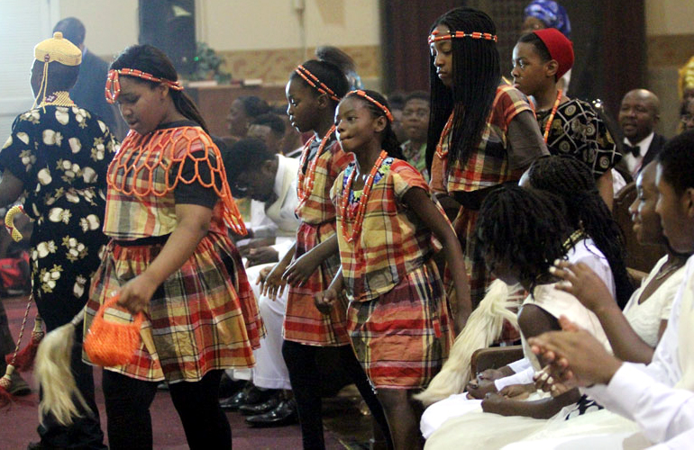Youth dance up the asile as the gift are brought up