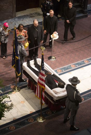 Bishop Robert E. Guglielmone of Charleston S.C., offers a prayer while paying his respects to the Rev. Clementa C. Pinckney, a pastor and state senator, inside the South Carolina Statehouse in Columbia June 24.  (CNS photo/Mic Smith, The Catholic Miscellany) 