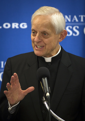 Cardinal Donald W. Wuerl of Washington addresses media at the National Press Club in Washington June 18 about the U.S. perspective on Pope Francis' encyclical on the environment. (CNS photo/Tyler Orsburn)