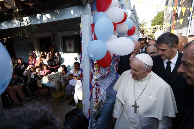 Pope Francis arrives to meet people gathered at a house as he visits Banado Norte, a poor neighborhood in Asuncion, Paraguay, July 12. (CNS photo/Paul Haring) 