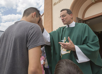 Msgr. Joseph V. Brennan, pictured giving a blessing outside Mother of Sorrows Church in Los Angeles July 19, has been named by Pope Francis as an auxiliary bishop for the Archdiocese of Los Angeles. Msgr. Brennan, 61, vicar general and moderator of the curia in Los Angeles since 2013, is a native of Van Nuys, Calif. (CNS photo/John Rueda, The Tidings) 