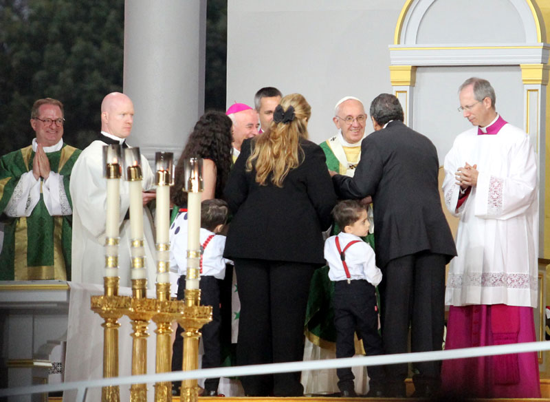 Pope Francis greets families at the end of mass. Photo by Sarah Webb