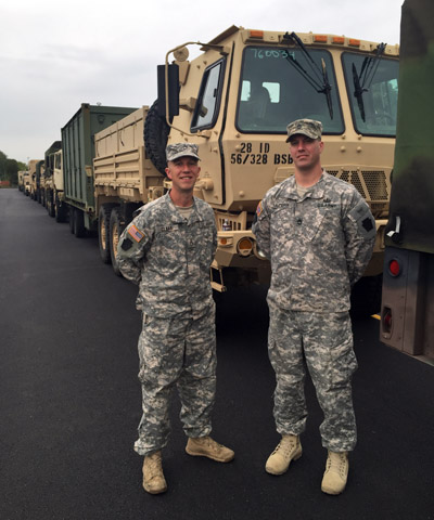 Staff Sgt. Christopher Claar, left, and Sgt. 1st Class Timothy Mudery pose with their convoy of vehicles from the 56th Striker Brigade of the Pennsylvania National Guard. They were en route to Philadelphia Sept. 21 to help provide security for the visit of Pope Francis Sept. 26-27. (Photo by Mary Solberg)