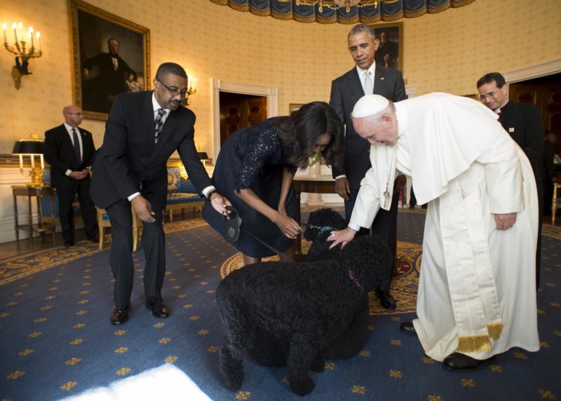 U.S. President Barack Obama and first lady Michelle Obama introduce their Portuguese water dogs, Bo and Sunny, to Pope Francis in the Oval Office at the White House Sept. 23 in Washington. (CNS photo/L'Osservatore Romano handout via Reuters) See POPE-WHITE-HOUSE Sept. 23, 2015.