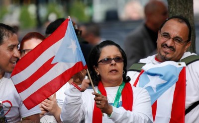 A woman holds the flag of Puerto Rico as Pope Francis addresses a crowd at Independence Hall in Philadelphia Sept. 26. In his talk the pope spoke about religious freedom and immigration. (CNS photo/Paul Haring) 