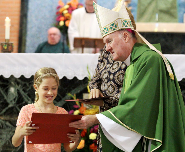 Andrea Verch  receives her Archdiocesan award from Bishop Fitzgerald.