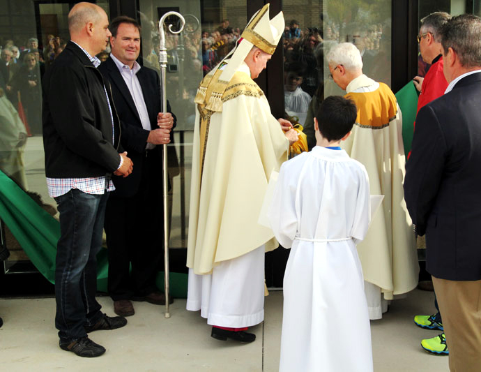 Bishop Michael Fitzgerald and Fr. Anglelo Citino cut the ribbon to the new gym.