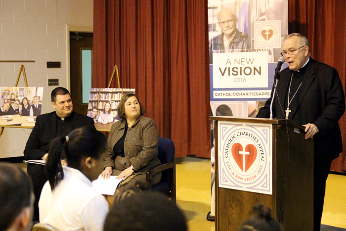 Archbishop Charles Chaput kics off the 2016 Catholic Charities Appeal Jan. 28 at St. Katherine Day School in Wynnewood. With him on the dais speaking to students and guests are Father Thomas Whittingham (left), pastor of St. Katharine Drexel Parish in Chester, and Kathleen Gould, principal of St. Katherine Day School for cognitively and developmentally challenged children. (Photo by Sarah Webb)