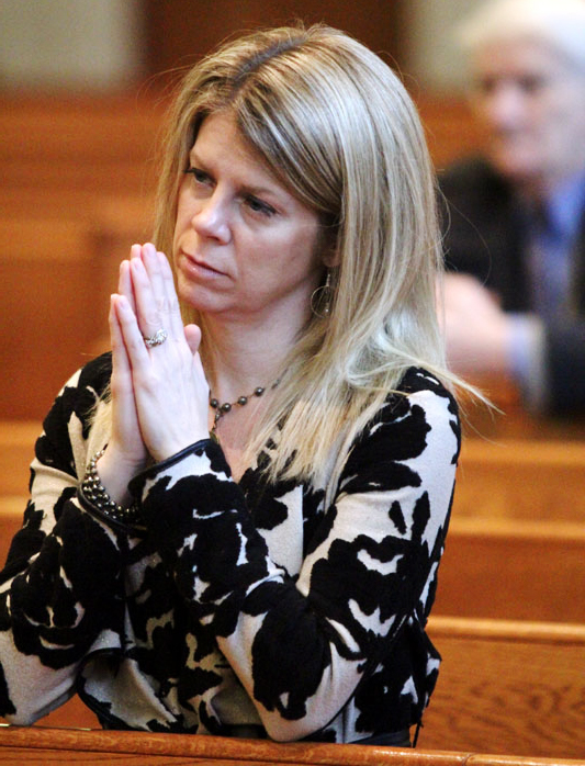 Jenny Galiani, co-founder of Adoption Is A Loving Option, prayes during Mass at the ProLife Summit.
