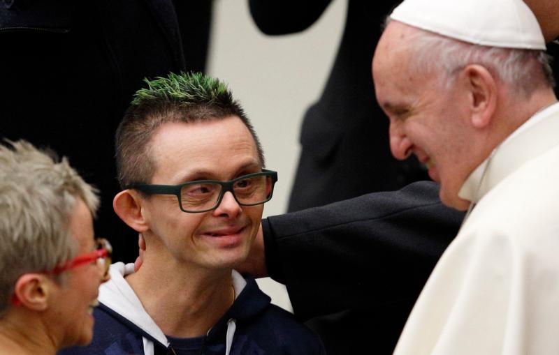 Pope Francis meets a man with green hair as he greets the disabled during his general audience in Paul VI hall at the Vatican Jan. 13. (CNS photo/Paul Haring)