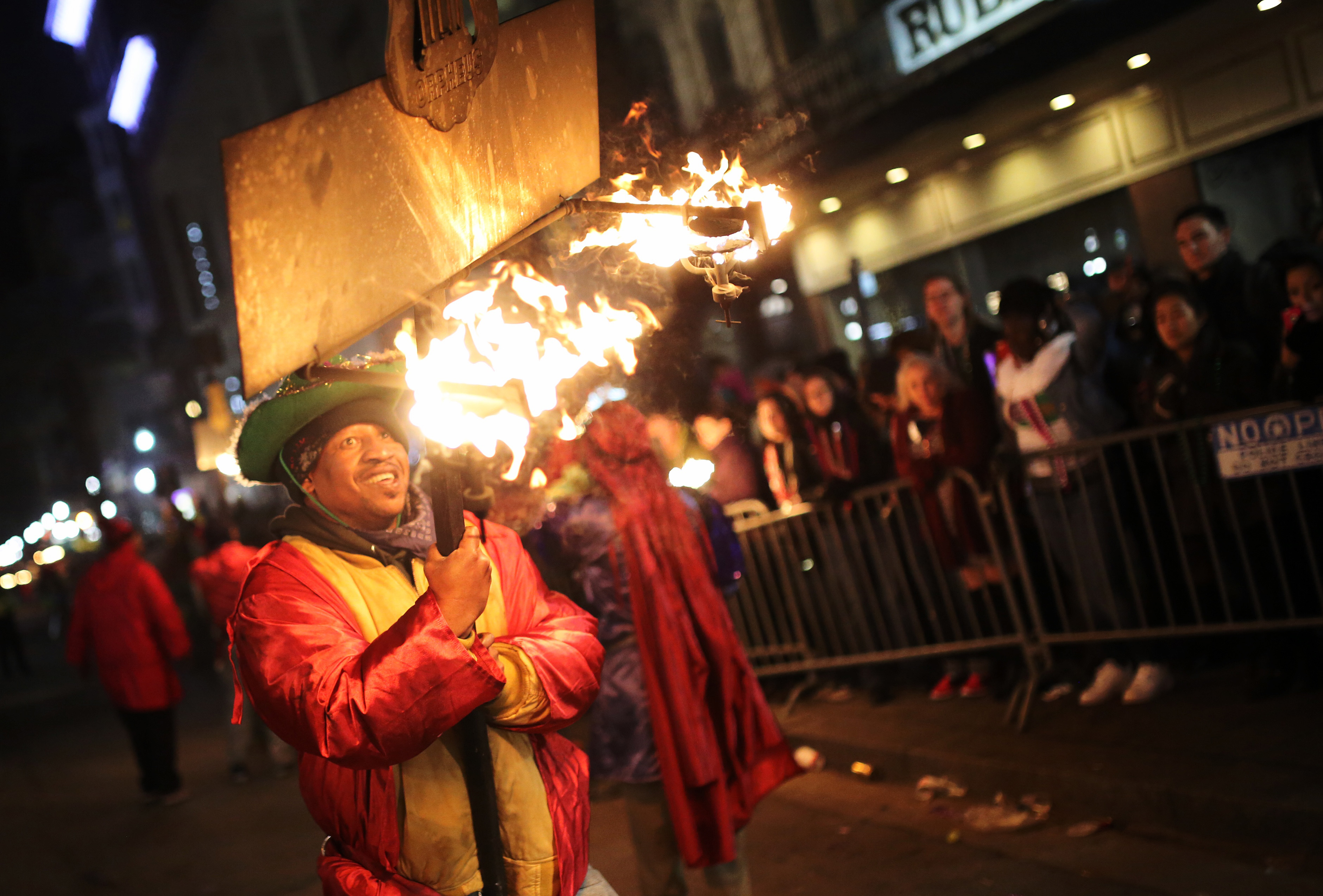 A flambeaux marches Feb. 7 in a parade in New Orleans. The parade took place in advance of Mardi Gras, or Fat Tuesday, which is a time of celebration the day before Ash Wednesday and the beginning of the church's Lenten period. (CNS photo/Dan Anderson, EPA)