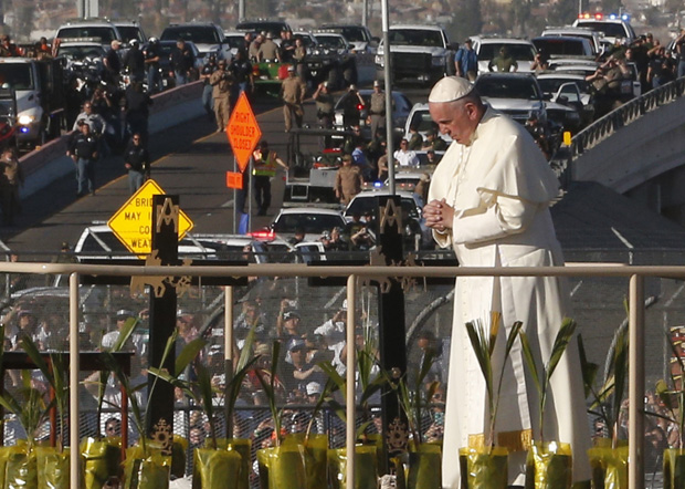 Pope Francis prays at a cross on the border with El Paso, Texas, before celebrating Mass at the fairgrounds in Ciudad Juarez, Mexico, Feb. 17. (CNS photo/Paul Haring)