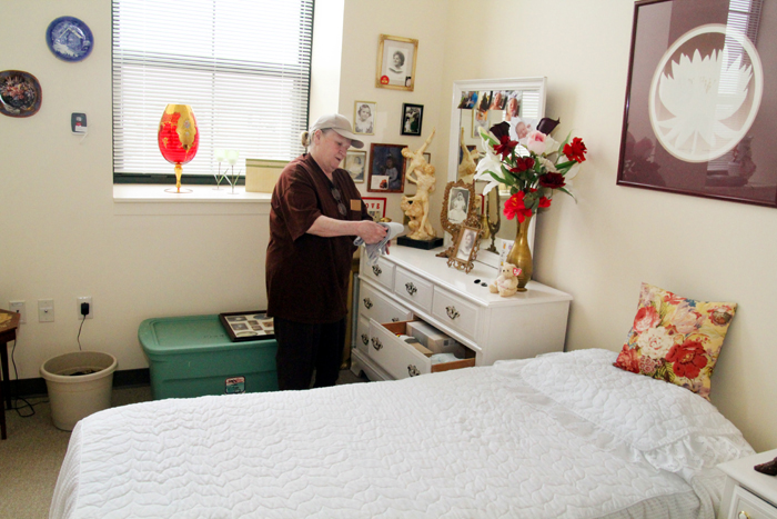 Theresa Beckowski put away clothes in her new bedroom.  She is very pleased with the size of her new apartment.