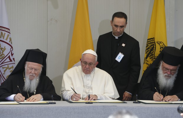 Ecumenical Patriarch Bartholomew of Constantinople, Pope Francis and Orthodox Archbishop Ieronymos II of Athens and all of Greece sign a joint declaration during a meeting with refugees at the Moria refugee camp on the island of Lesbos, Greece, April 16, 2016. (CNS photo/Paul Haring)