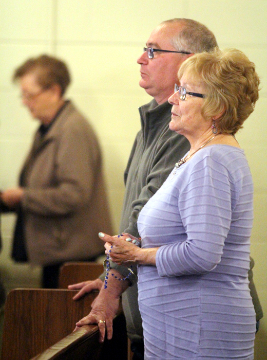 Jim Varnes attends mass with his mother Dolly.