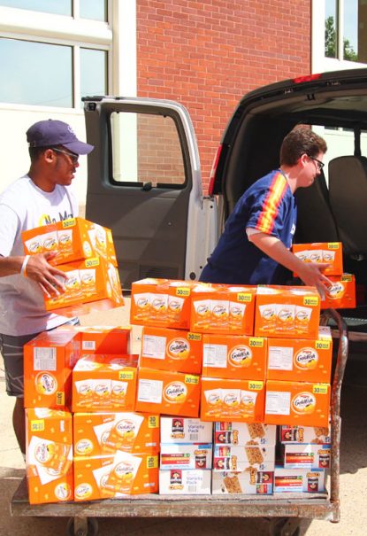 Students of St. Joseph's Prep load up snacks for delivery to Nutritional Development Services and later distribution at sites of the Summer Feeding Program. (Sarah Webb)