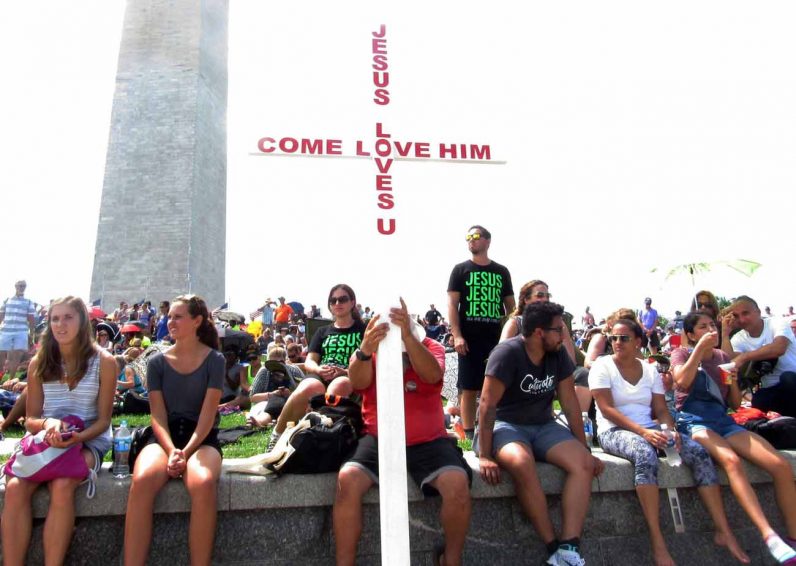 A man holds a cross during the "Together 2016" event in Washington July 16. (CNS photo/Ana Franco-Guzman)