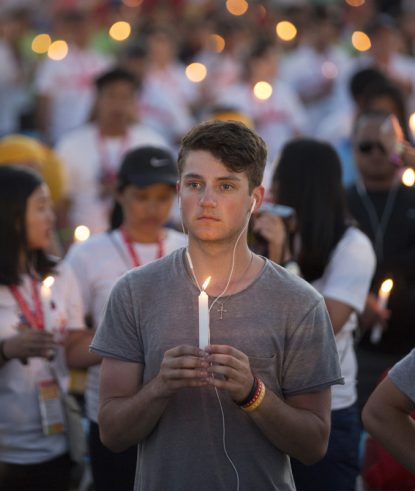 World Youth Day pilgrims hold candles during eucharistic adoration with Pope Francis at the July 30 prayer vigil at the Field of Mercy in Krakow, Poland. (CNS photo/Jaclyn Lippelmann, Catholic Standard)