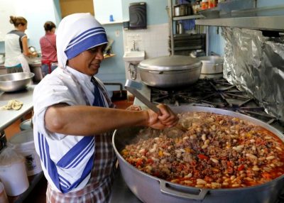 Sister Marie Frank, a member of the Missionaries of Charity, prepares lunch in a soup kitchen run by her order in an apartment building in the South Bronx section of New York Aug. 24. (CNS photo/Gregory A. Shemitz)