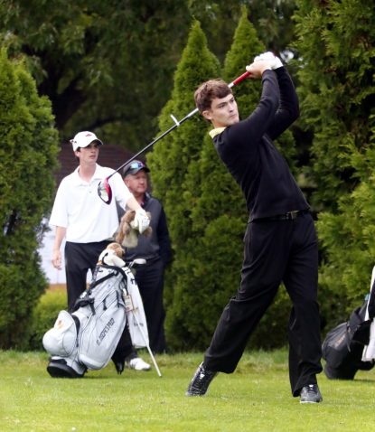 Alex Durelli drives his first shot in the first hole of a sudden death playoff at the Catholic League championship Oct. 4 as his opponent, Andrew Gallagher looks on.