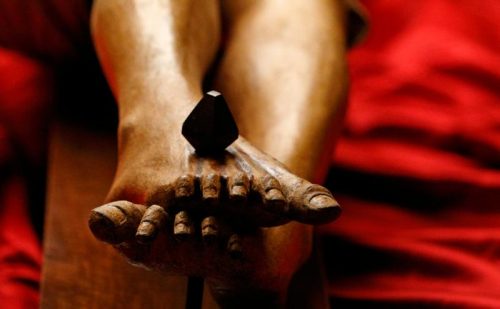 The feet of a wooden crucifix from the 14th century are seen during a media opportunity to showcase its restoration in St. Peter's Basilica at the Vatican Oct. 28. (CNS photo/Paul Haring)