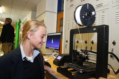 Gracie Terry, fresman student in the EAST Program, demonstrates the school's 3D printer.