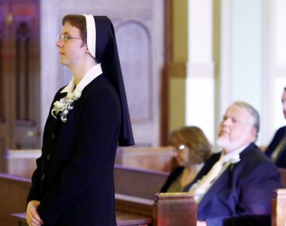Sister Maria Sophia Gerlach professes her vows in the Sisters of the Holy Family of Nazareth Nov. 12 in the chapel of Nazareth Academy High School as her parents, Tina and George Gerlach, witness the rite.