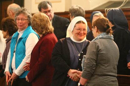 Participants in the Mass at St. Vincent's Seminary before the Jan. 6-7 meeting of the Vincentian executive committee exchange a sign of peace. (Sarah Webb) 