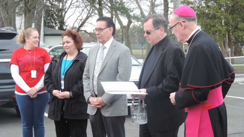 Bishop Michael Fitzgerald, right, and Father Joseph Watson, pastor of Nativity of Our Lord, lead prayers at the dedication of the Precious Friends of St. Gianna Childcare Center, March 30.