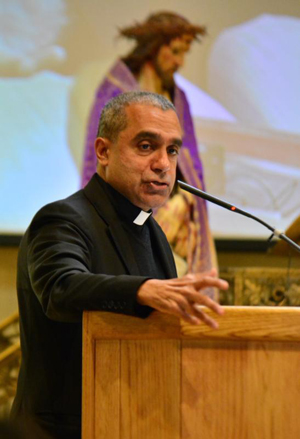 Msgr. Anthony Figueiredo, regional coordinator of the Migrants and Refugees Section of the Vatican's Dicastery for Promoting Integral Human Development, speaks March 11 at SS. Cyril and Methodius Parish in Sterling Heights, Mich., during the annual Holy Trinity Apostolate Symposium. (CNS photo/Mike Stechschulte, The Michigan Catholic) 