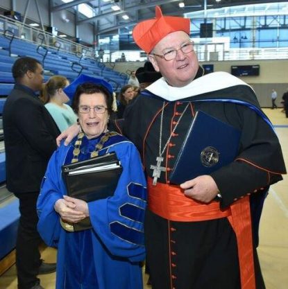 Neumann University President Rosalie Mirenda stands with Cardinal Timothy Dolan at the Charter Day festivities March 15.