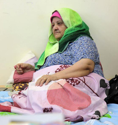 An Iraqi Christian woman who fled from violence in Mosul, Iraq, rests on a bed in 2014 at Mar Elias Monastery Church in Amman, Jordan. Catholic leaders have expressed concern for tens of thousands of Iraqi Christian refugees sheltering in Jordan as access to international aid tightens with crises deepening in the Middle East and elsewhere. (CNS photo/Jamal Nasrallah, EPA) 