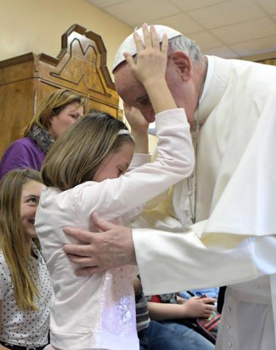 Pope Francis greets a girl as he visits the Sant' Alessio-Margherita di Savoia Regional Center for the Blind March 31 in Rome. (CNS photo/L'Osservatore Romano) See POPE-MERCY-FRIDAY-BLIND March 31, 2017.