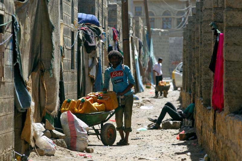 A man stands next to a wheelbarrow in a shantytown in Sana'a, Yemen, Feb. 6, a scene reminiscent of the kind of poverty Blessed Paul VI addresses in his 1967 social encyclical "Populorum Progressio" ("The Progress of Peoples"). Blessed Paul also spoke of problems of rich nations and companies within those nations continuing to take advantage of the poor. (CNS photo/Yahya Arhab, EPA) 