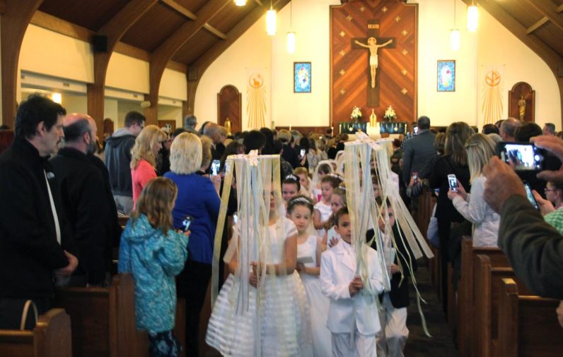 Children of Our Lady of Fatima Parish, Secane, lead the recessional at the close of Mass on Saturday, May 13, at which they received their first holy Communion.