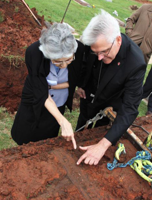 Archbishop Paul S. Coakley of Oklahoma City and Sister Marita Rother, a member of Adorers of the Blood of Christ, who is the sister of Father Stanley Rother, examine the nameplate on his vault May 9 at Holy Trinity Cemetery in Okarche, Okla. Father Rother, a North American priest who worked in Guatemala and was brutally murdered there in 1981, will be beatified Sept. 23 in Oklahoma. (CNS photo/Diane Clay, Sooner Catholic) See ROTHER-EXHUMATION May 17, 2017.