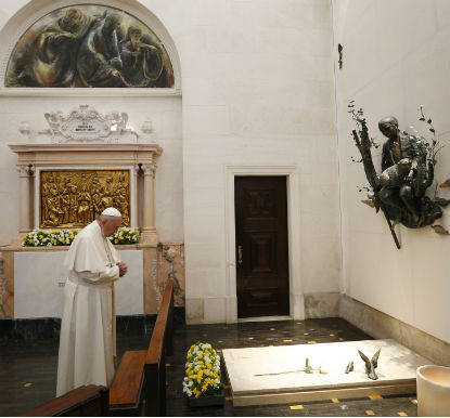 Pope Francis prays at the tomb of Fatima seer Francisco Marto before celebrating the canonization Mass for him and his sister, Jacinta Marto, at the Shrine of Our Lady of Fatima in Portugal, May 13. (CNS photo/Paul Haring)