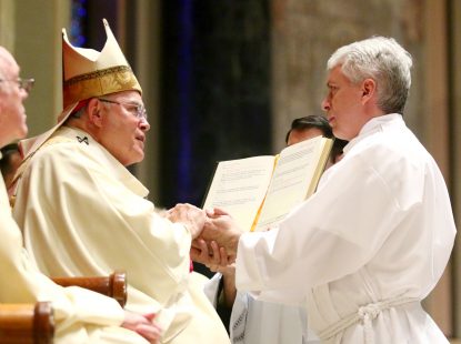Christopher C. Roberts makes the promise of the elect during his ordination to the permanent diaconate.